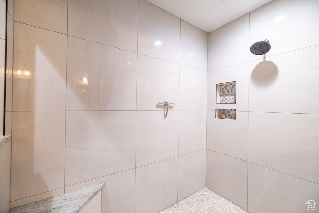 Full bath with a tile shower