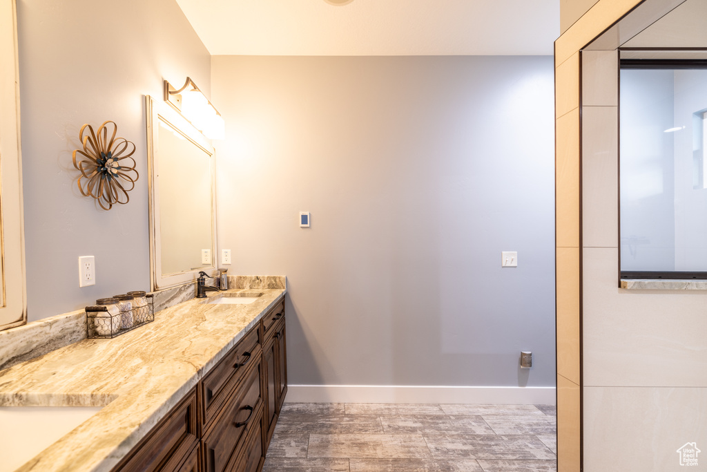 Bathroom featuring double vanity and wood finished floors