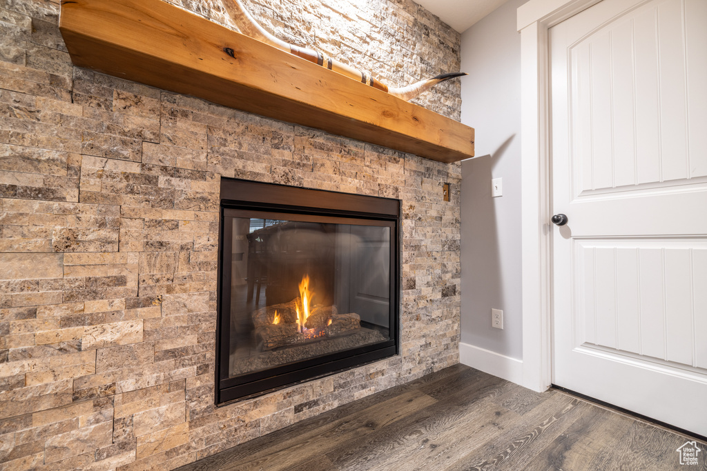 Detailed view of wood finished floors and a glass covered fireplace