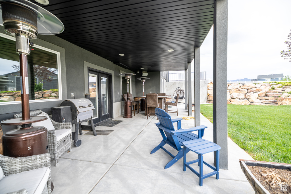 View of patio with french doors, outdoor dining space, and area for grilling