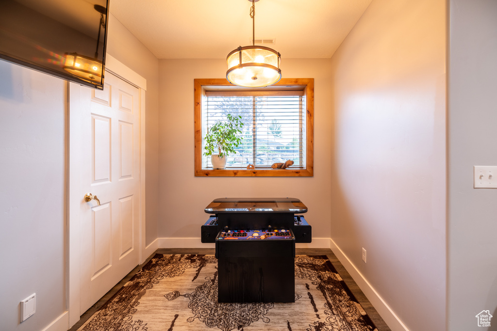 Office area with baseboards and wood finished floors