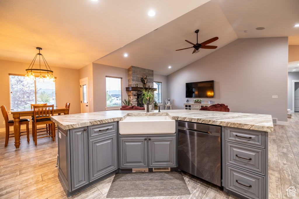 Kitchen featuring dishwasher, gray cabinets, a ceiling fan, open floor plan, and lofted ceiling