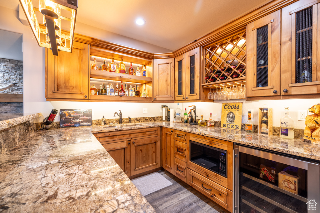 Indoor wet bar featuring wine cooler, black microwave, dark wood-type flooring, and recessed lighting