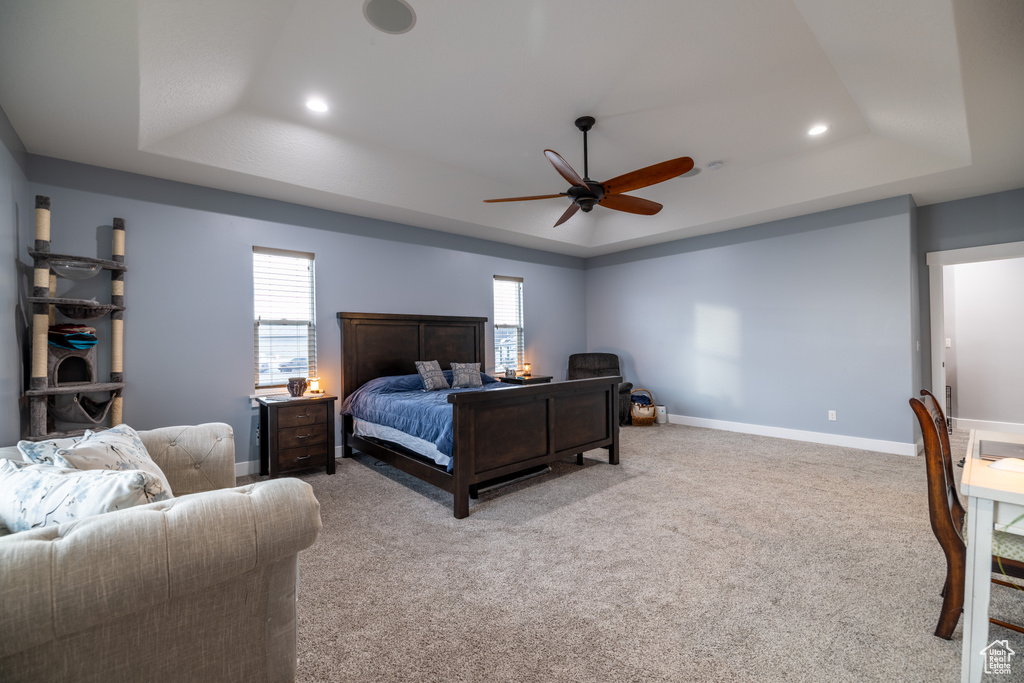 Bedroom with a tray ceiling, recessed lighting, carpet floors, and ceiling fan