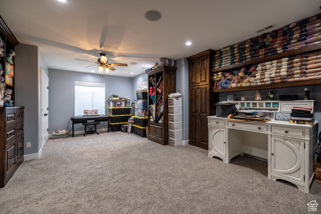 Carpeted home office featuring a ceiling fan and recessed lighting