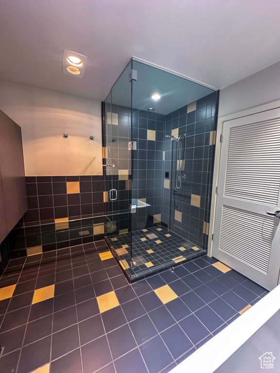 Bathroom featuring tile patterned floors and a stall shower