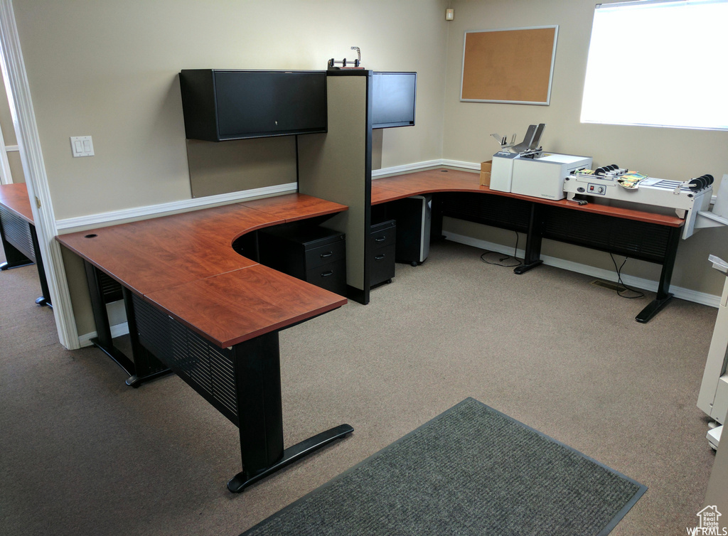 Home office with light colored carpet