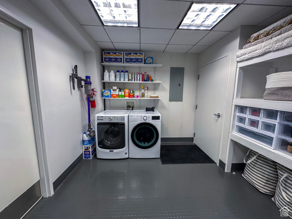 Laundry room featuring electric panel and separate washer and dryer