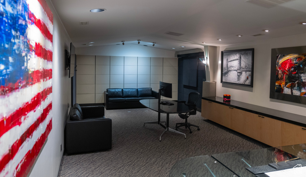 Interior space with lofted ceiling, tile walls, and recessed lighting