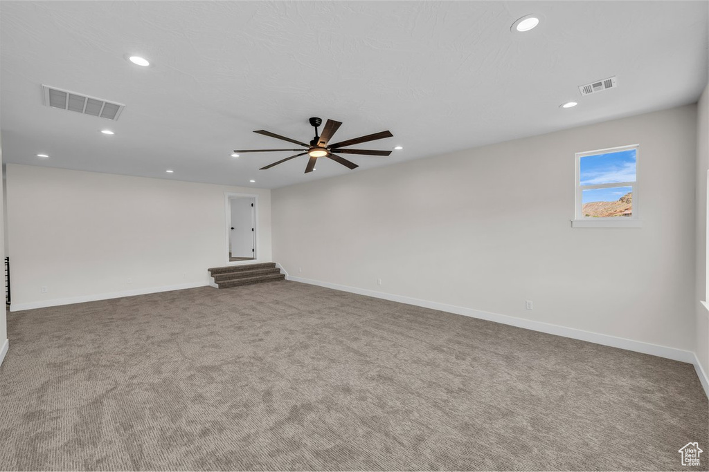 Spare room featuring carpet floors, a ceiling fan, and recessed lighting