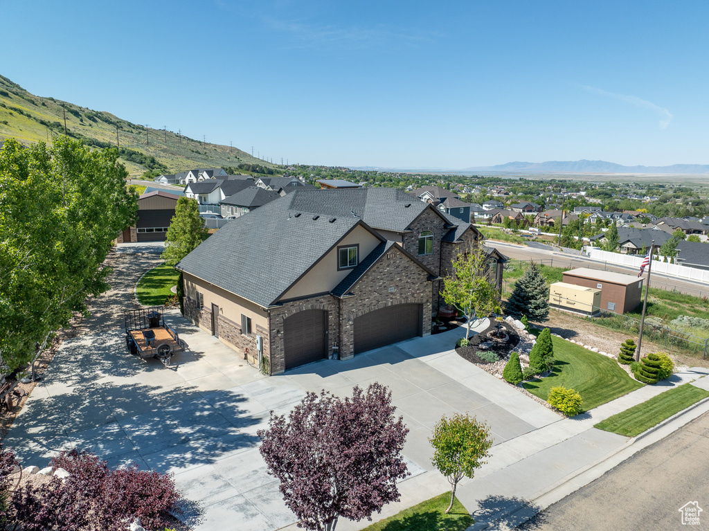 Aerial view of residential area featuring a mountainous background