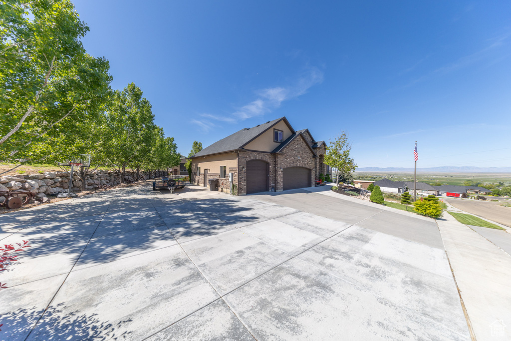 View of home's exterior with a mountain view and driveway