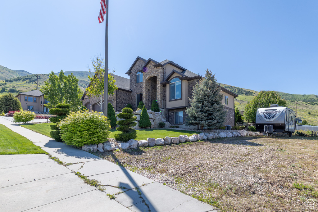 View of front facade with stone siding and a mountain view