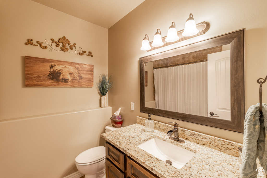 Full bath with vanity and a shower with shower curtain