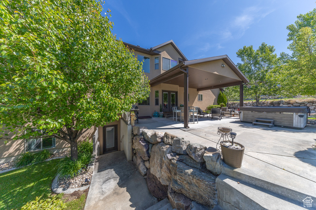 View of patio / terrace featuring a hot tub and french doors