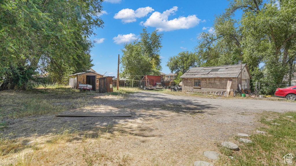 View of yard with a storage unit