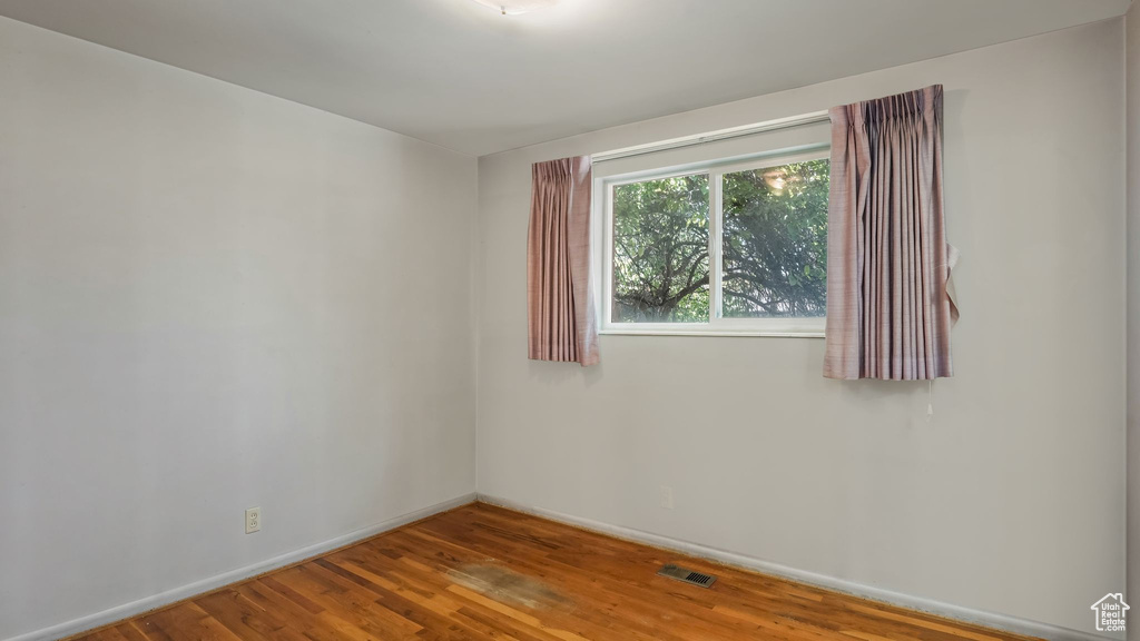 Empty room with wood finished floors and baseboards