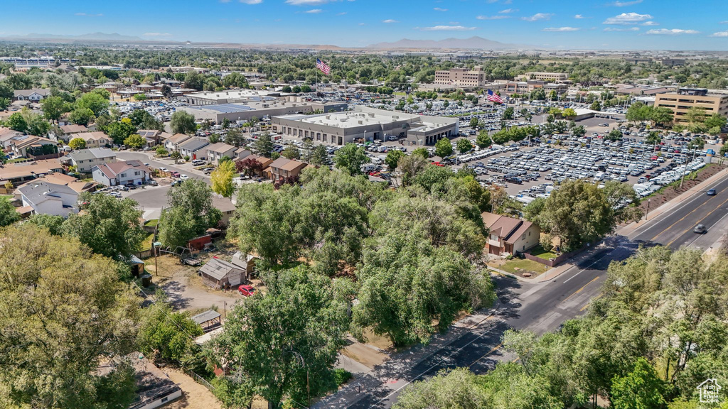 Aerial view of property and surrounding area with a mountain backdrop