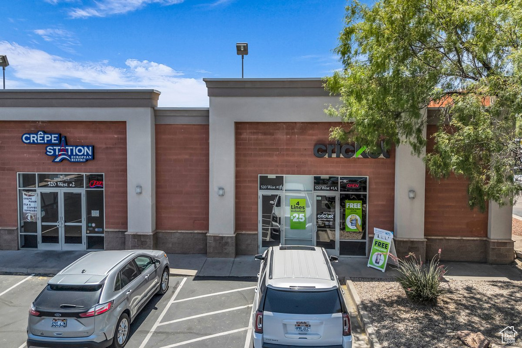 View of commercial property featuring uncovered parking