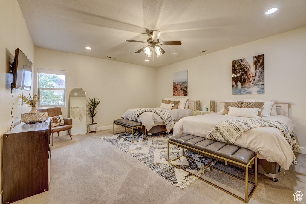 Bedroom featuring light colored carpet, recessed lighting, and ceiling fan