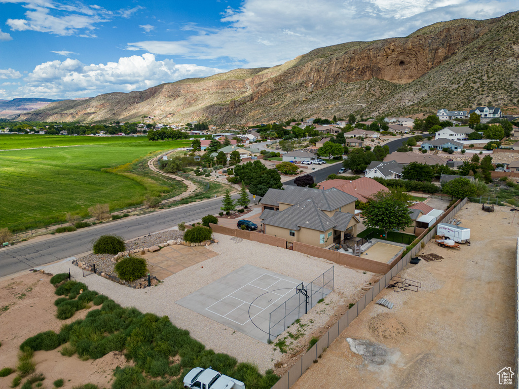 Aerial view of residential area with a mountain backdrop and a local golf course