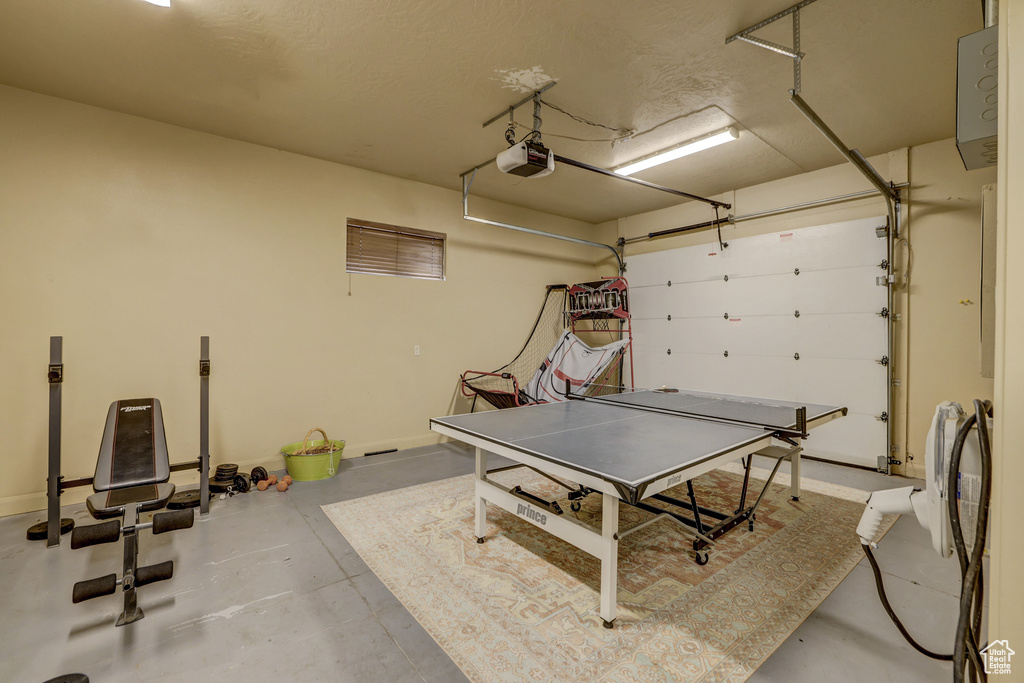 Garage with a garage door opener and baseboards