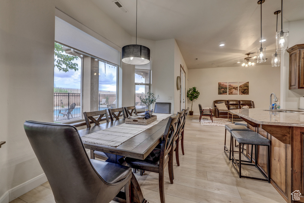 Dining space featuring recessed lighting, light wood finished floors, and a chandelier