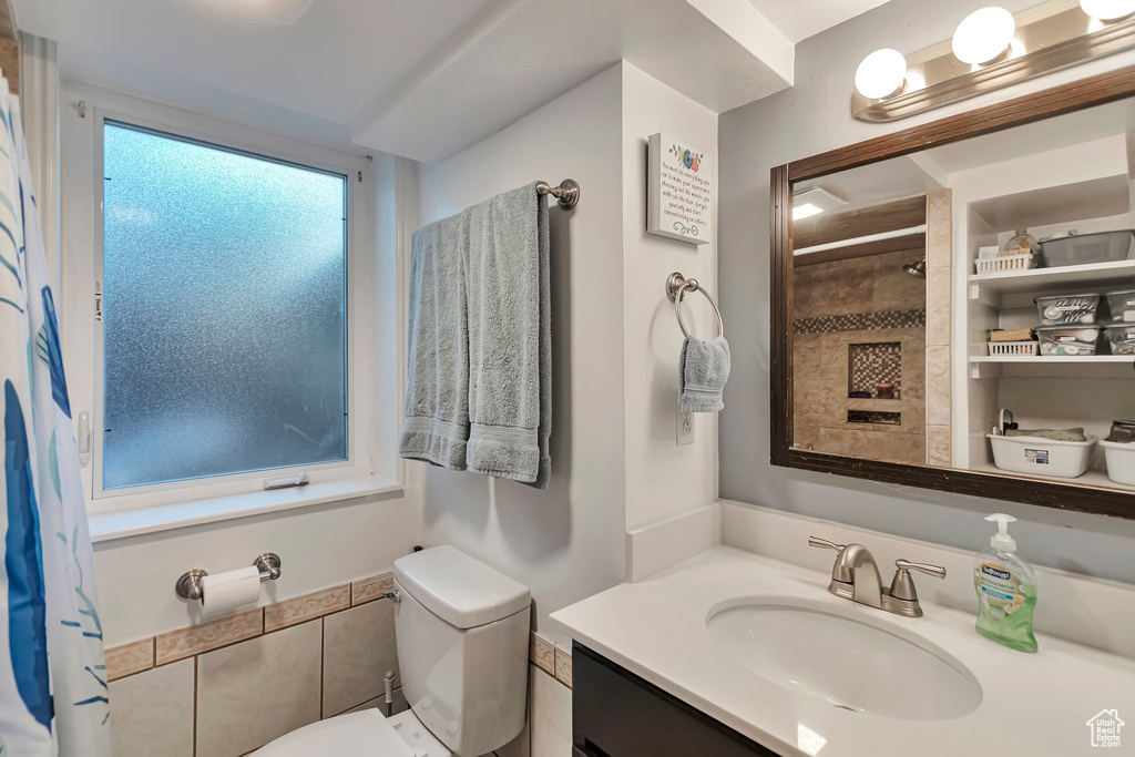 Full bath with vanity and a shower with curtain