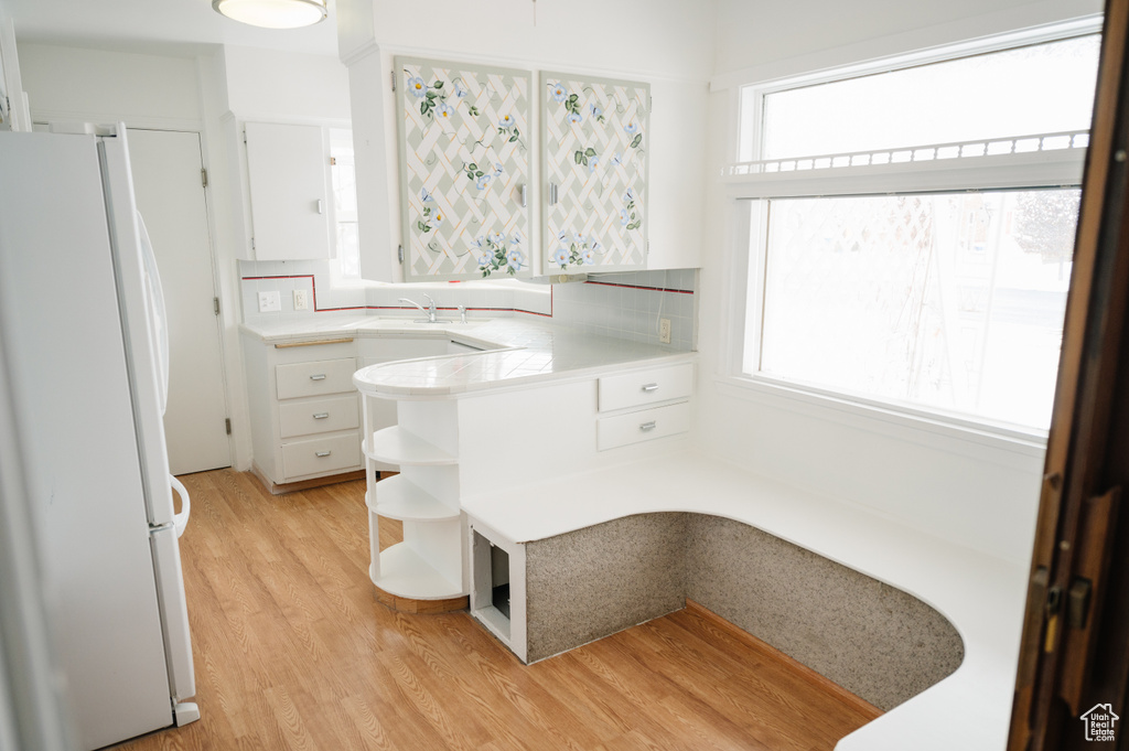 Bathroom with wood finished floors and plenty of natural light