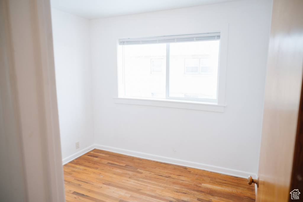 Empty room featuring light wood finished floors and baseboards