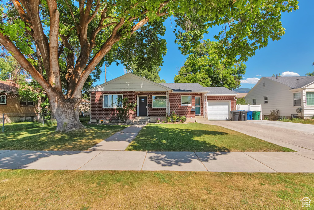 View of front of home featuring brick siding, an attached garage, and concrete driveway