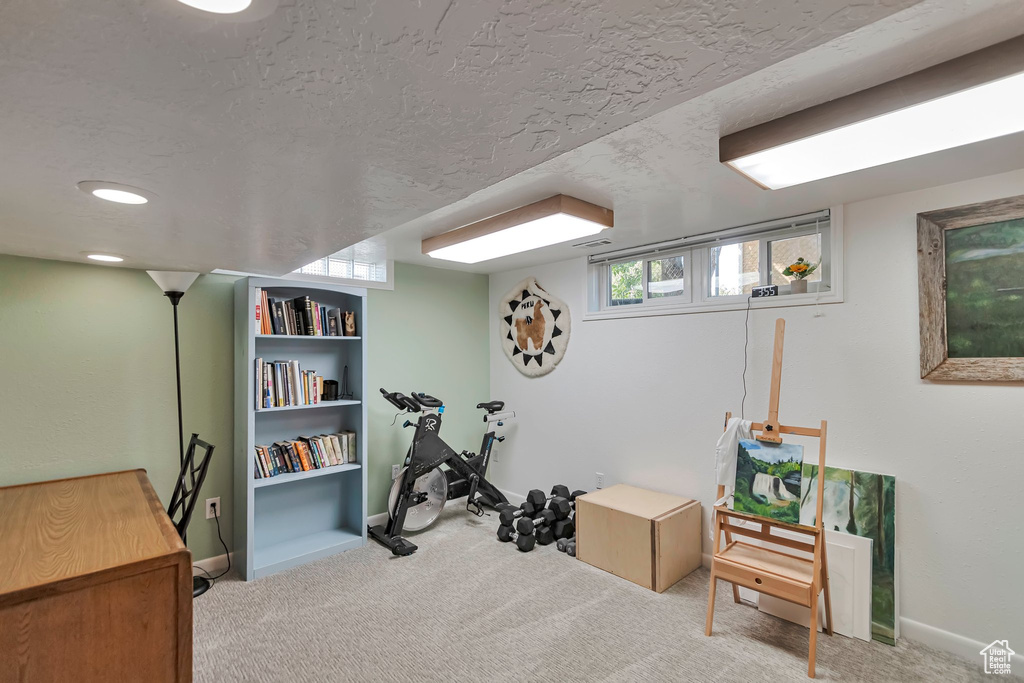 Exercise area with carpet and a textured ceiling