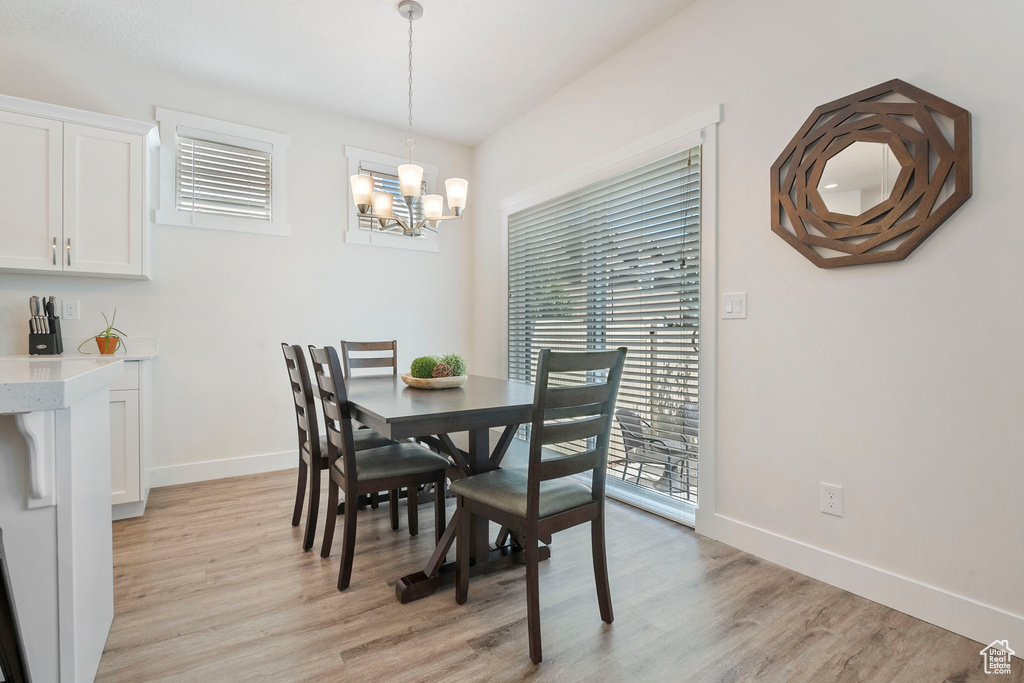 Dining space featuring light wood-style floors and a chandelier