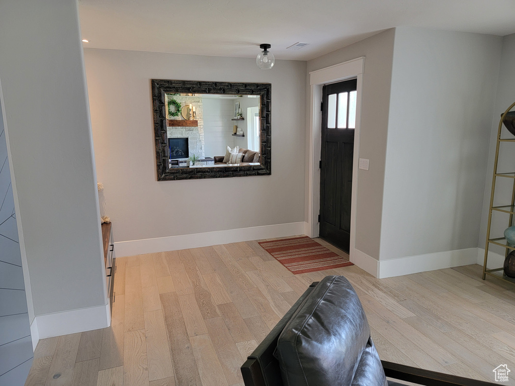 Entryway with wood finished floors and baseboards