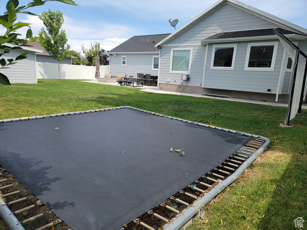 Back of property featuring a patio and roof with shingles