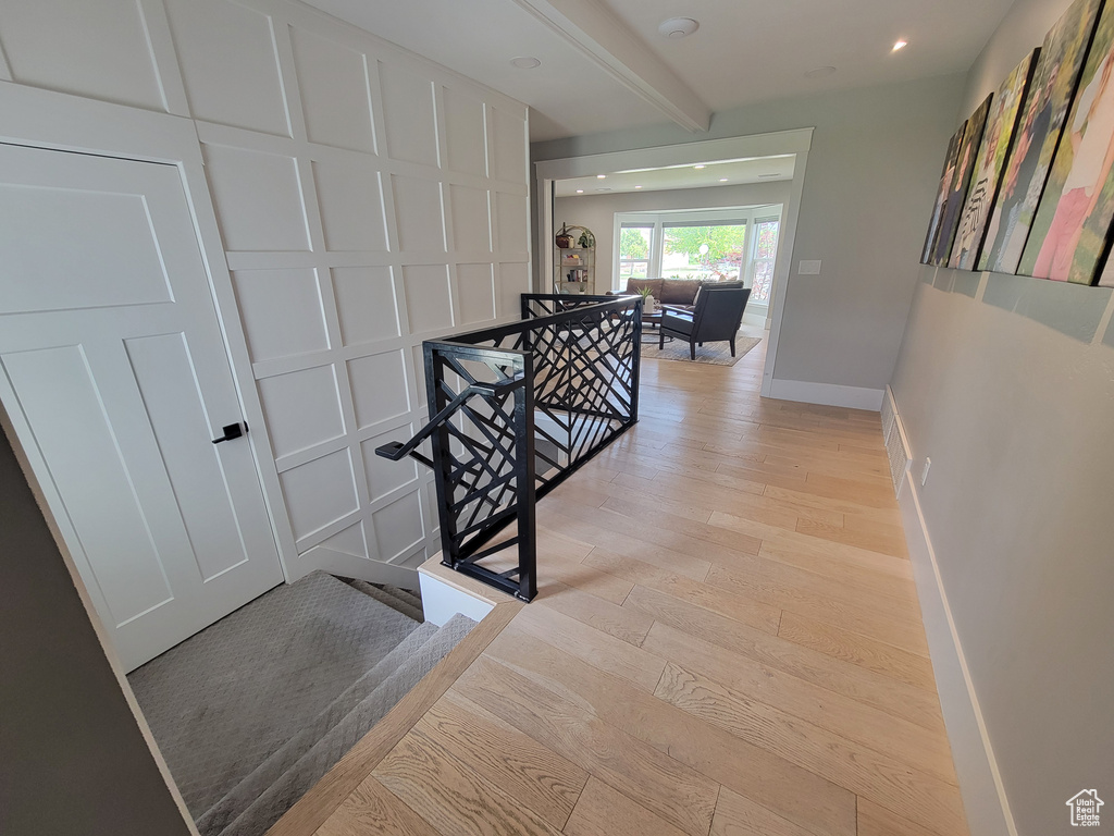 Staircase with hardwood / wood-style flooring and recessed lighting