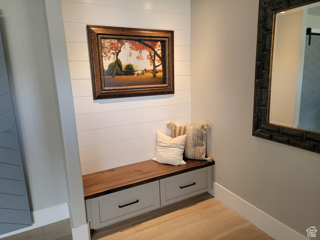 Mudroom featuring light wood-type flooring and baseboards