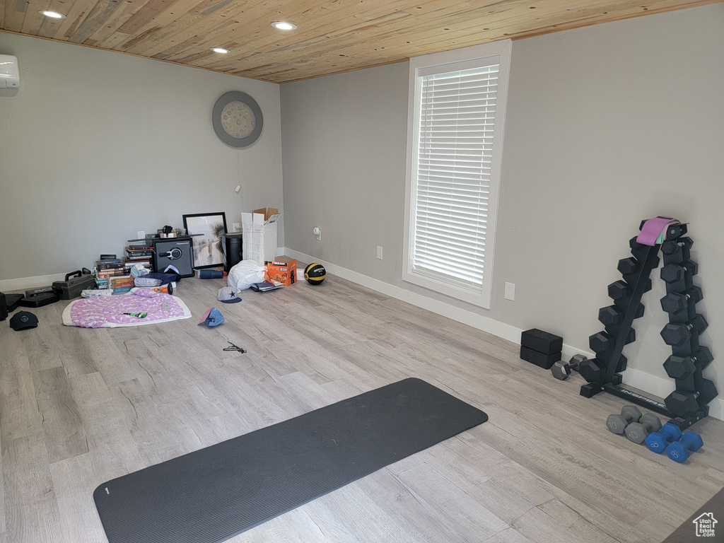 Workout area featuring wood finished floors, wood ceiling, recessed lighting, and a wall mounted AC