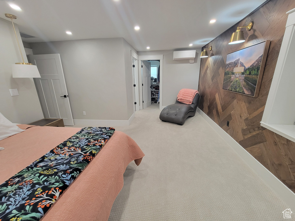 Bedroom with a wall mounted AC and recessed lighting