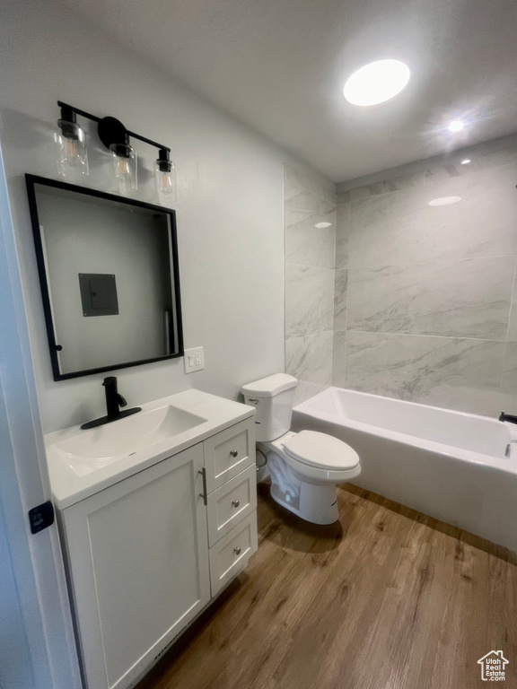 Full bathroom featuring vanity, wood finished floors, and bathing tub / shower combination