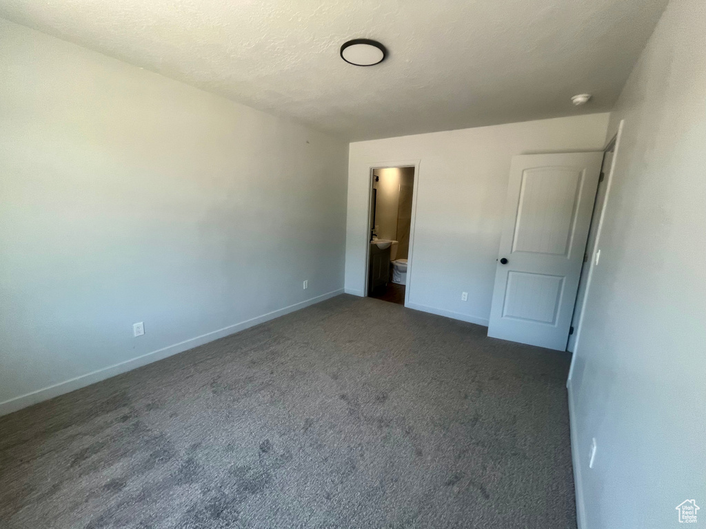 Unfurnished bedroom featuring carpet and baseboards
