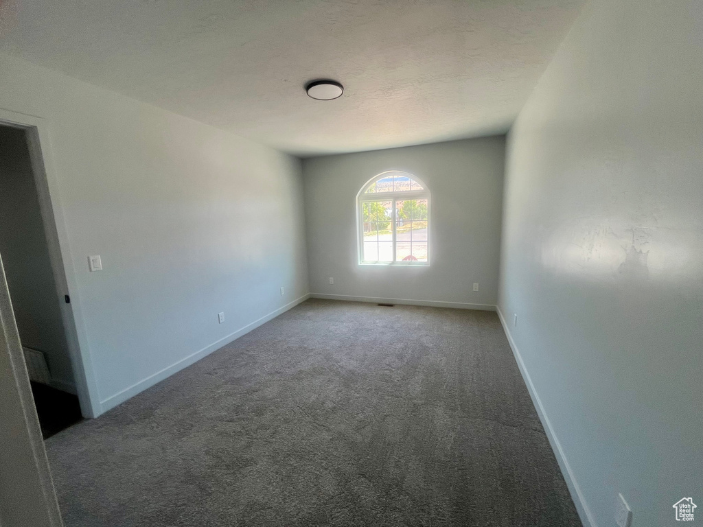 Spare room with carpet and baseboards
