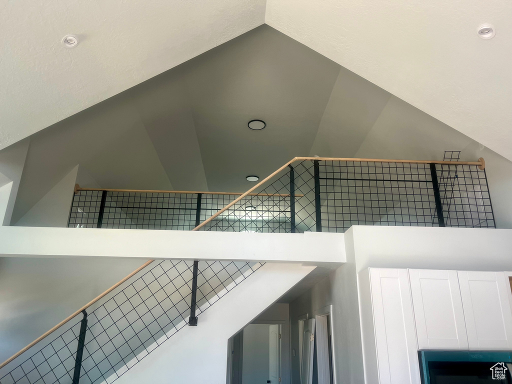 Staircase featuring vaulted ceiling and recessed lighting