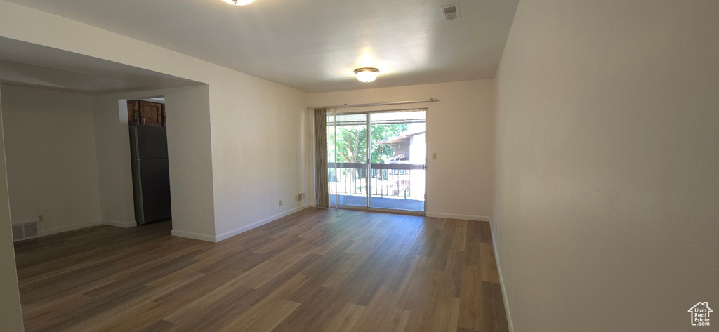 Empty room with baseboards and wood finished floors