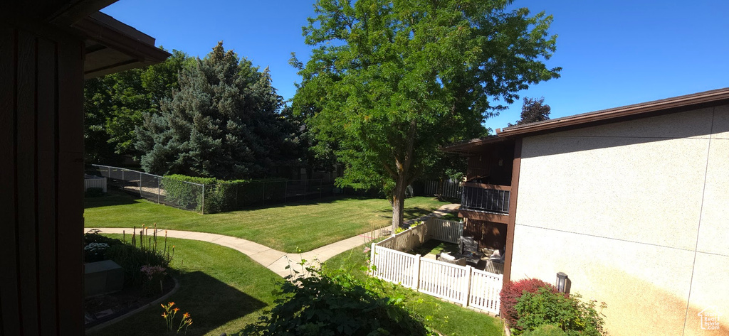 View of yard with a balcony