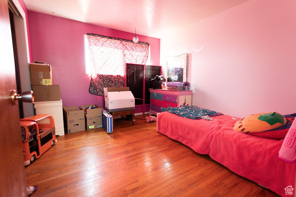 Bedroom with wood-type flooring and multiple windows