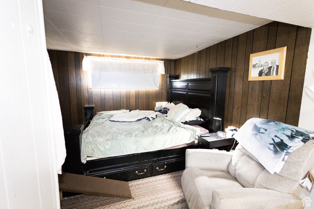 Carpeted bedroom with wooden walls