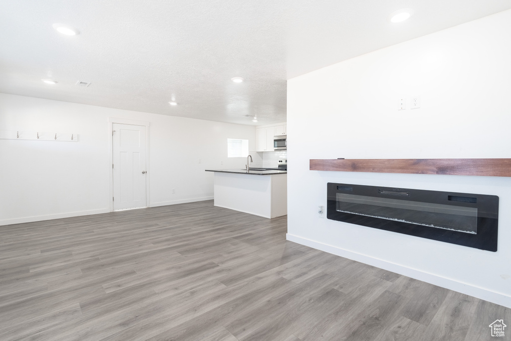 Unfurnished living room with recessed lighting and light wood finished floors