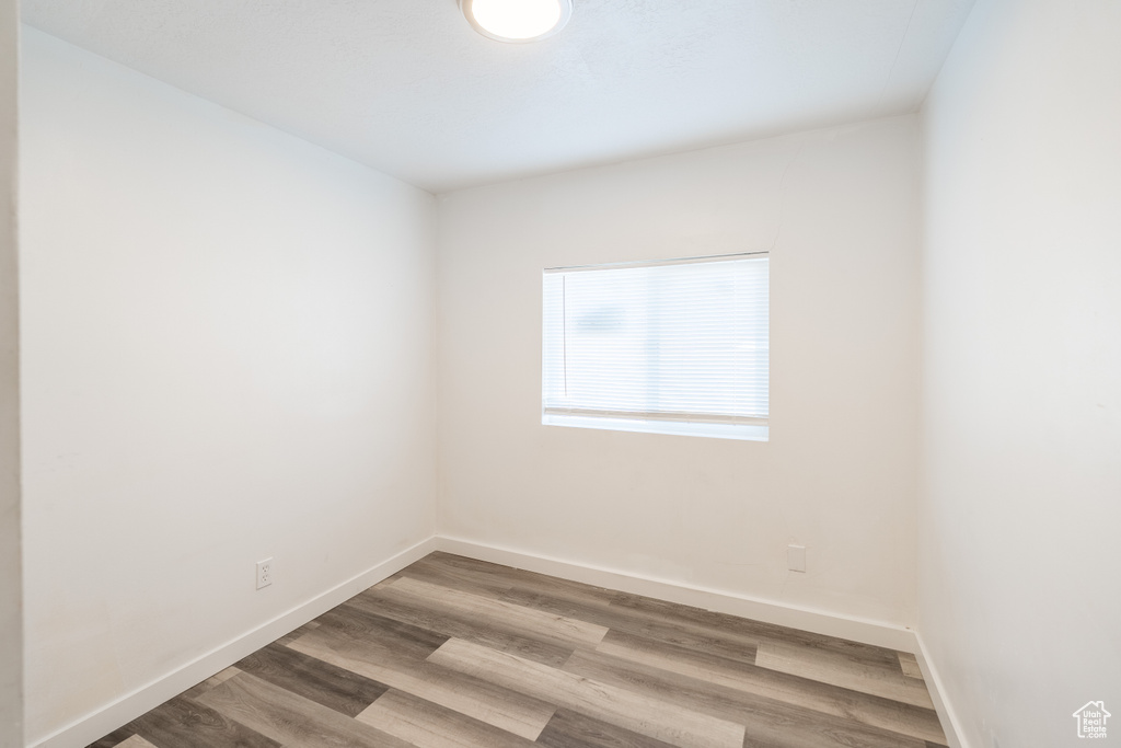 Empty room featuring wood finished floors and baseboards