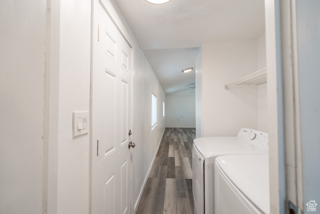 Laundry area with dark wood-type flooring and washing machine and dryer